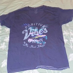 Dark blue t-shirt says “positive vibes”. Fairly new condition. Size medium.